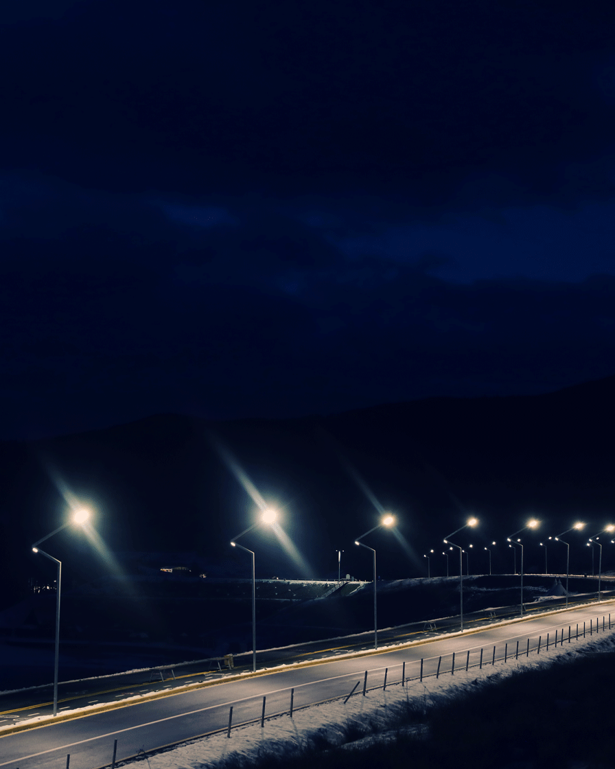 lit-mountain-road-with-snow-sides-evening-going-winter-vacation